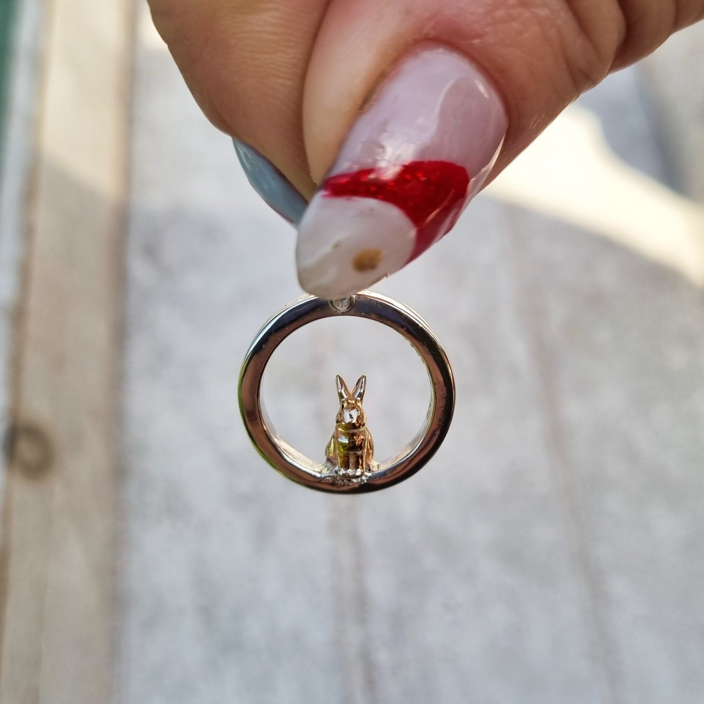 Teeny tiny gold bunny rabbit peeping out of silver halo