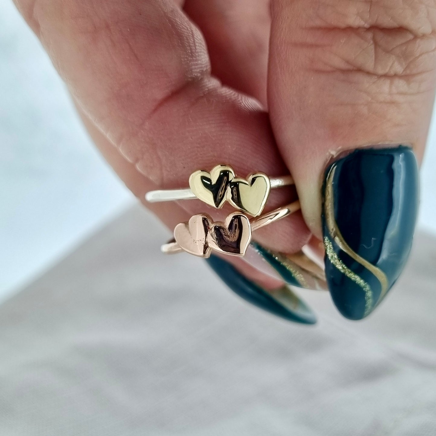 Shared Love - solid gold sweetheart ring with a pair of gold hearts