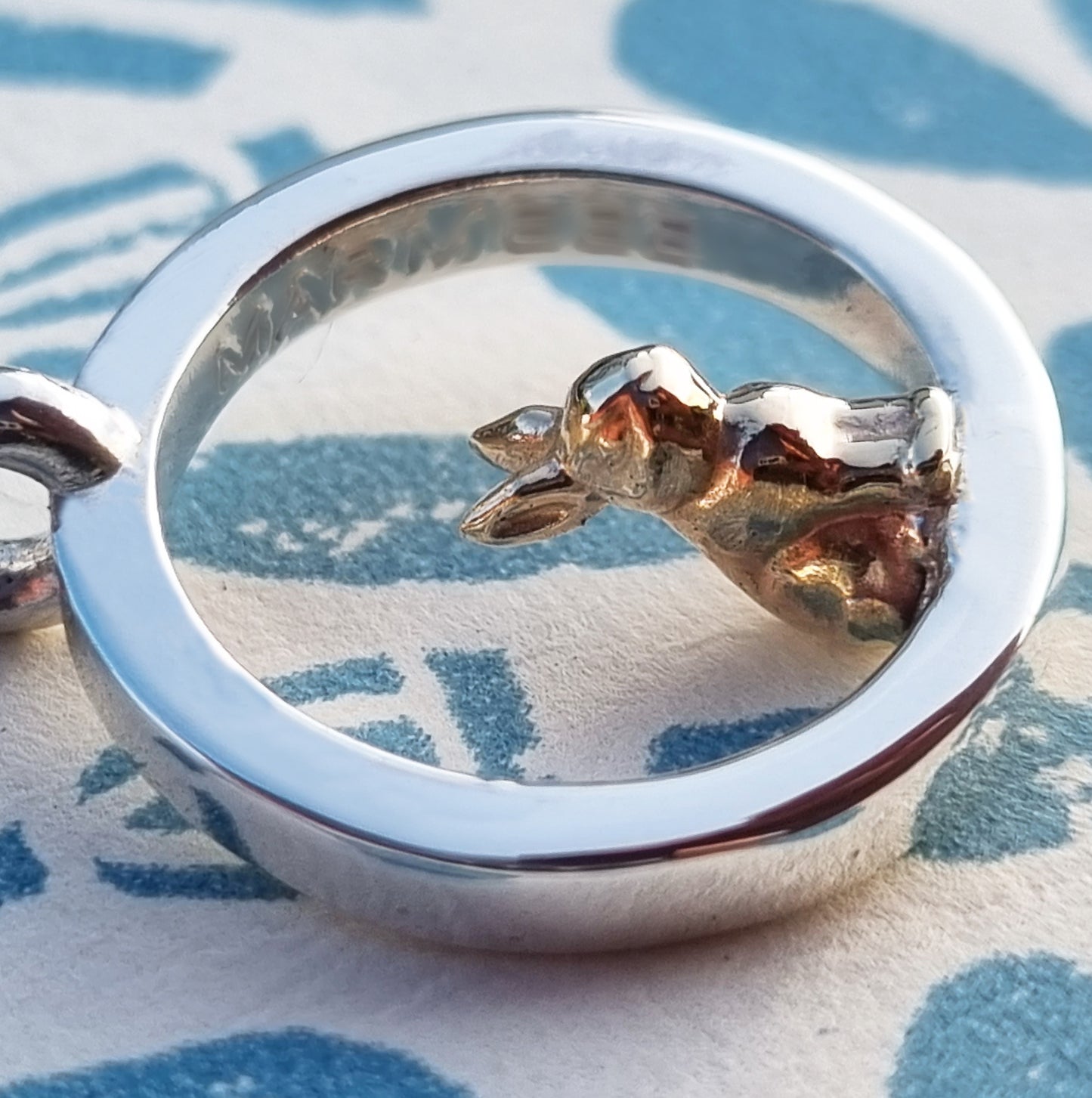 Teeny tiny gold bunny rabbit peeping out of silver halo