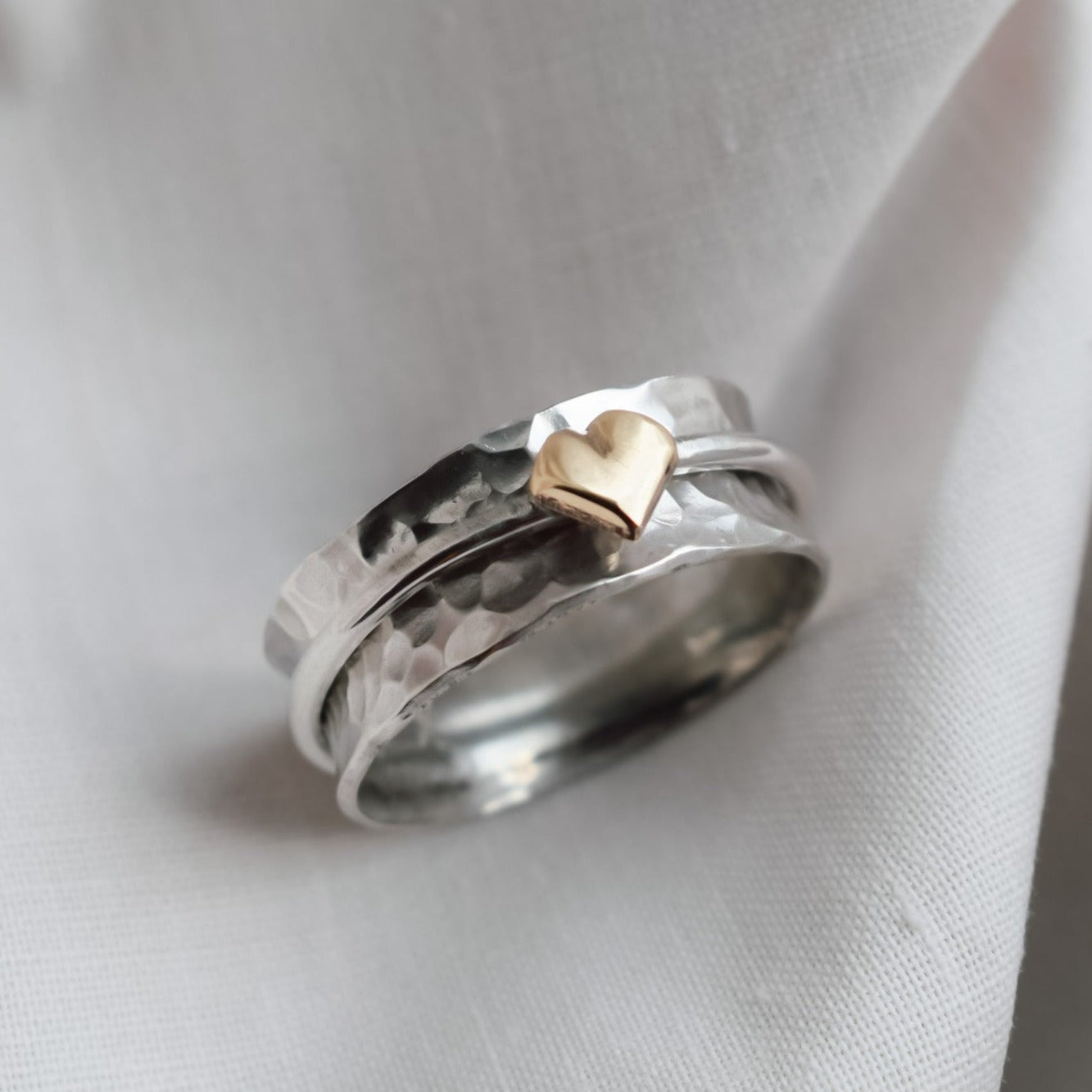 'One Love'. Sterling silver spinning ring with solid gold heart.