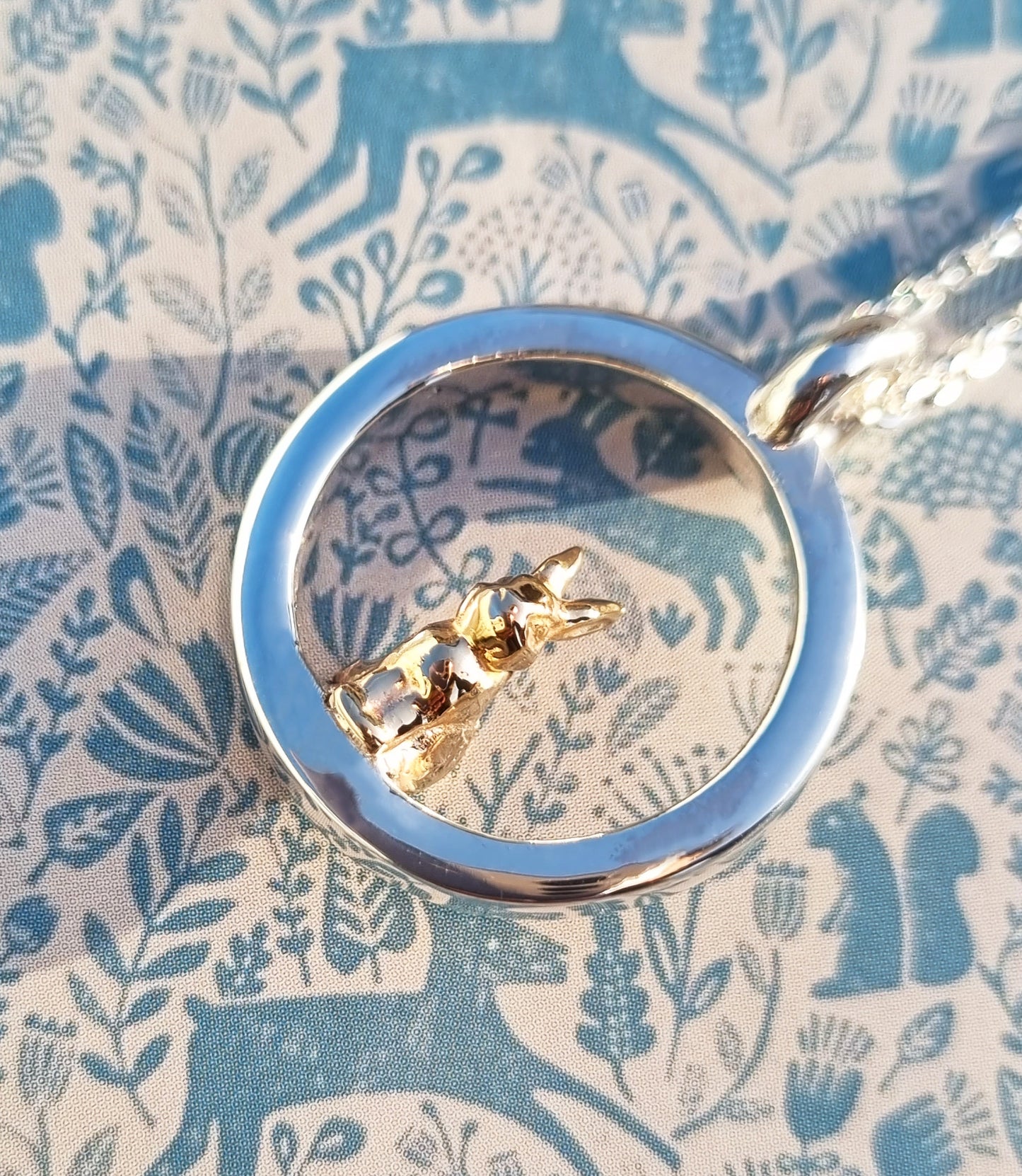 Teeny tiny gold bunny rabbit peeping out of silver halo