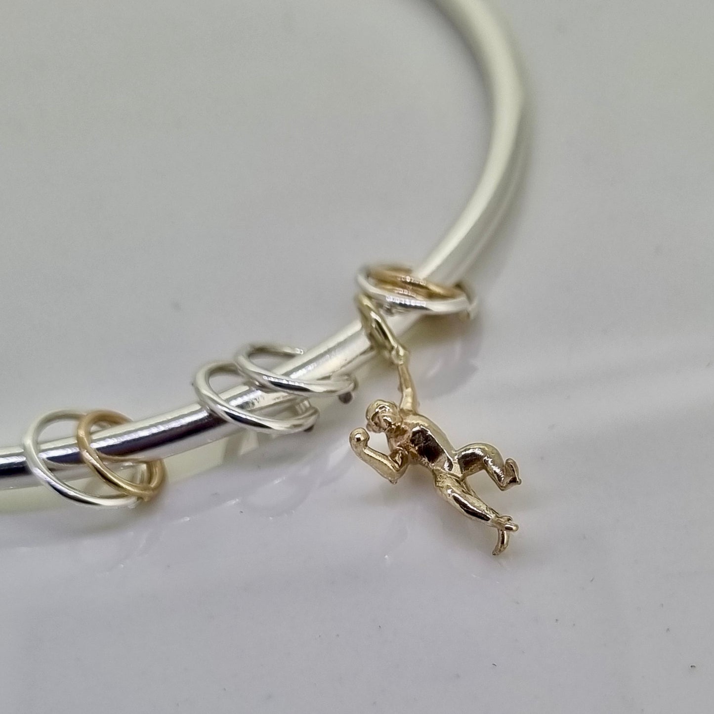 Monkey puzzle - silver bangle with gold monkey and sliding hoops