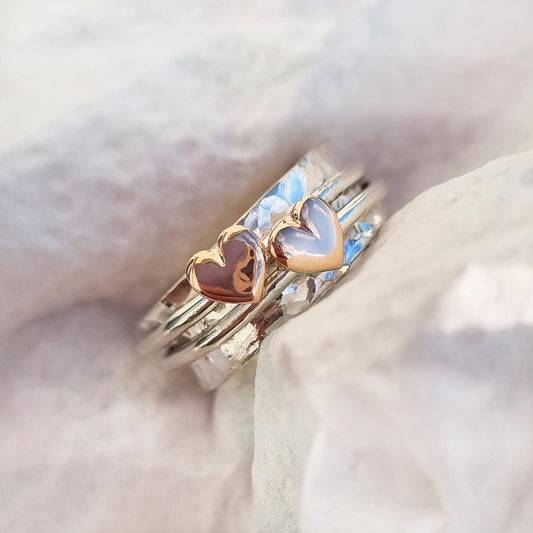 Two hearts beat as one. Gold or silver hearts.
