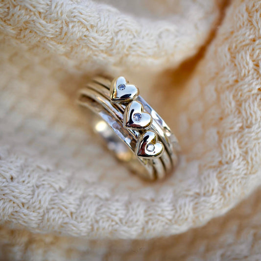 Spinning ring with diamonds set in three gold hearts