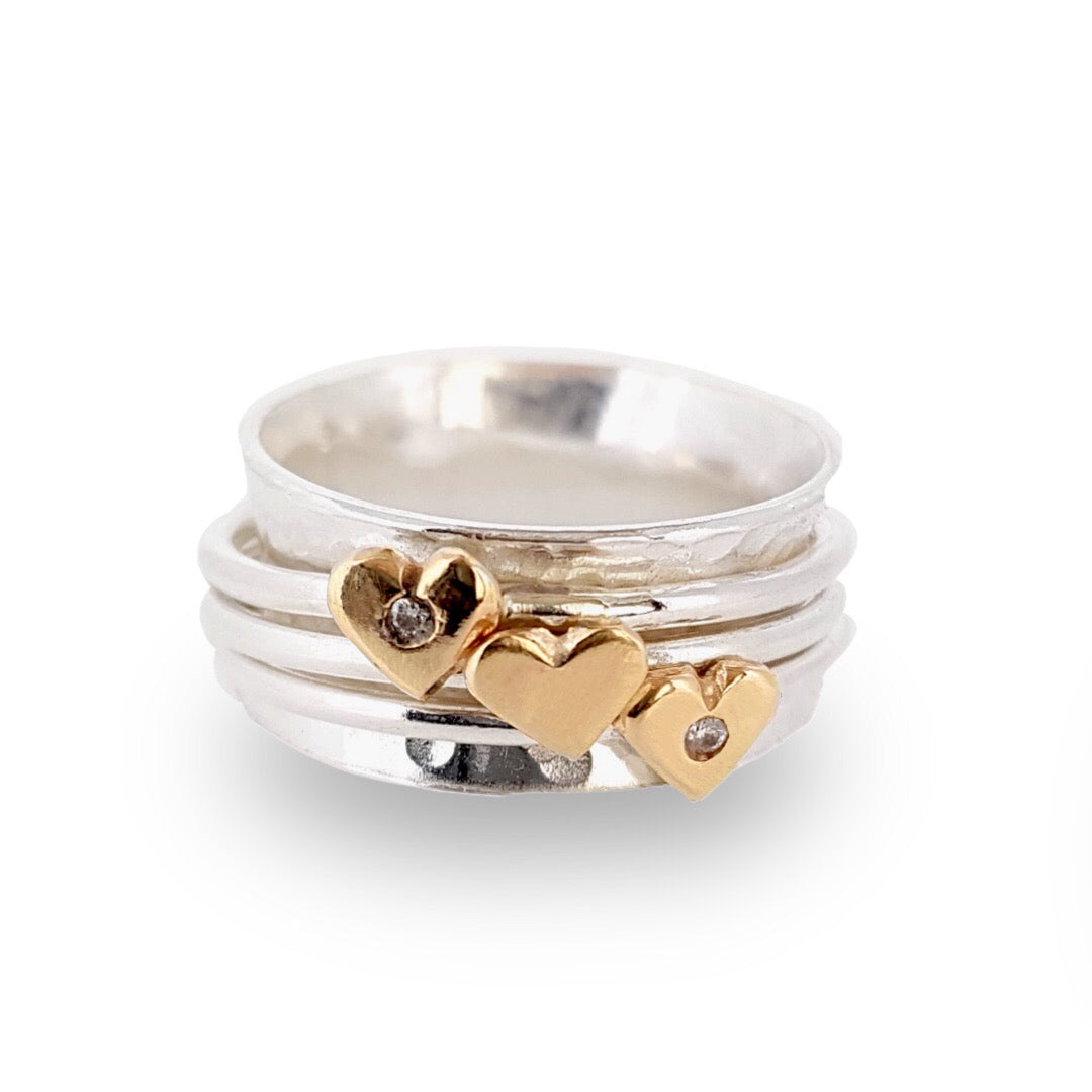 Spinning ring with diamonds set in three gold hearts