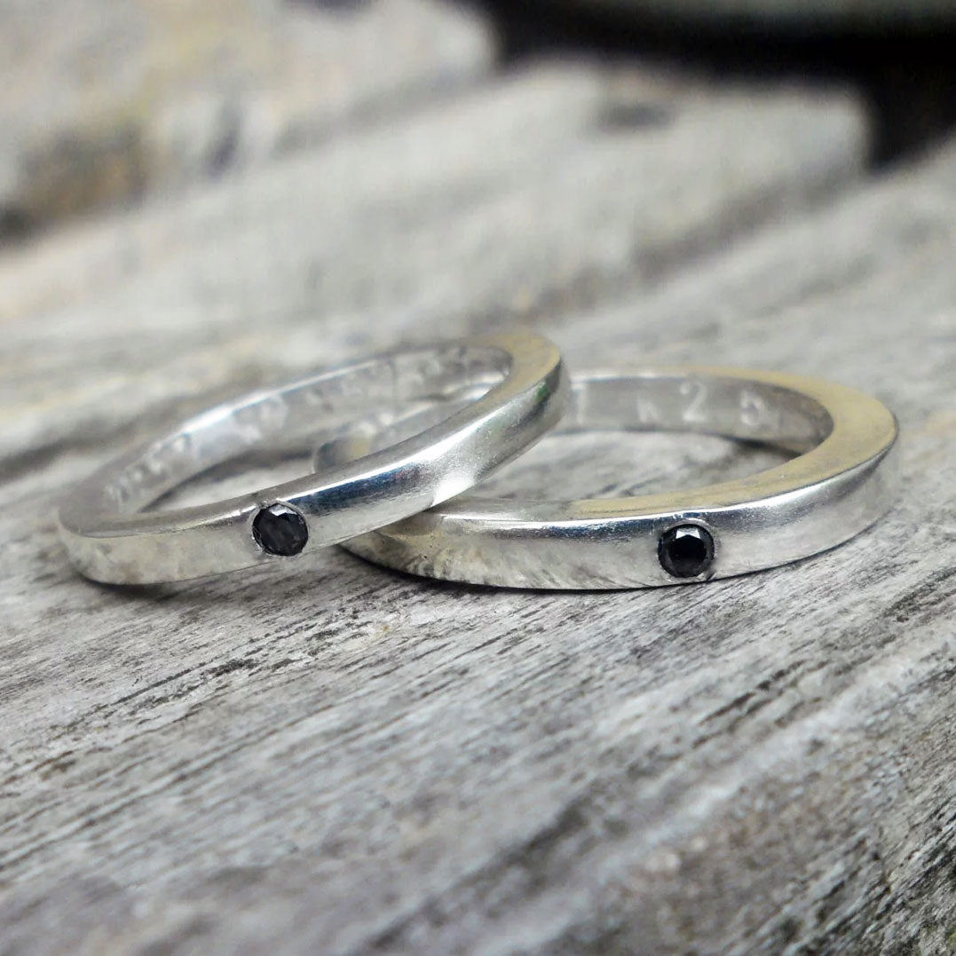 Silver wedding bands set with black diamonds