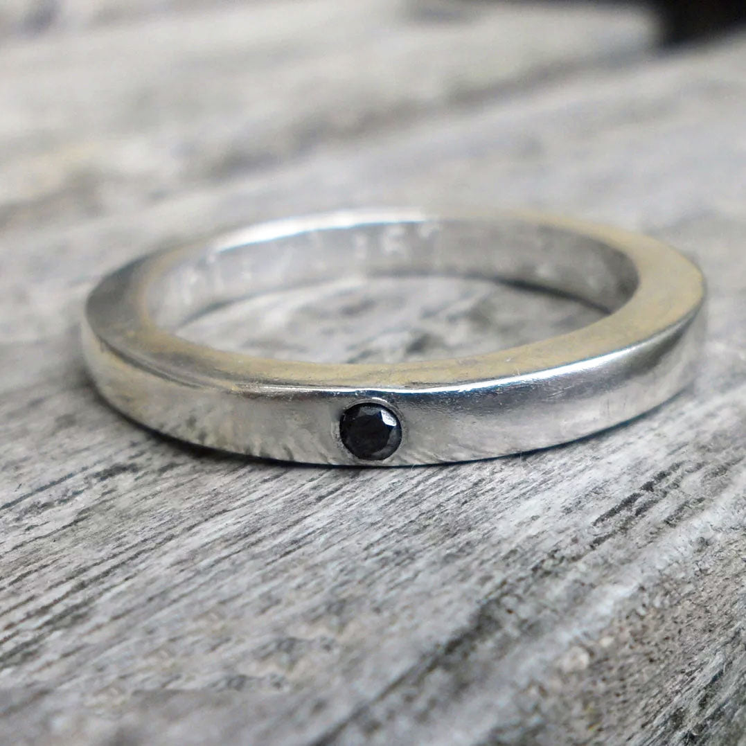 Silver wedding bands set with black diamonds