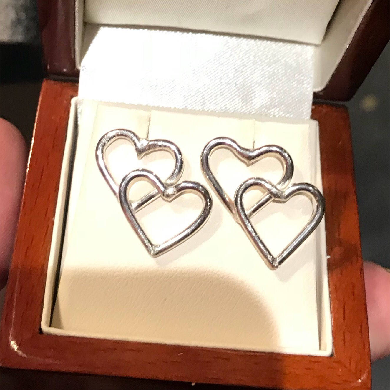 Solid silver double heart stud earrings.