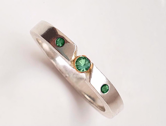 Triple emerald ring with gold bezel setting