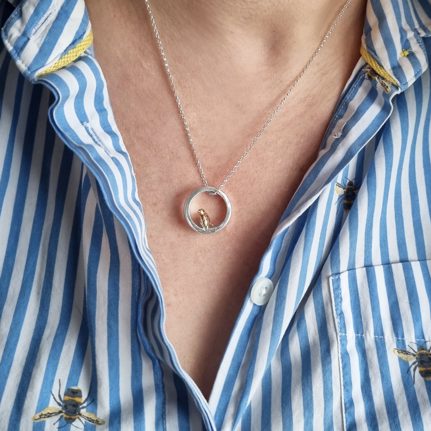 Teeny tiny gold robin peeping out of silver halo