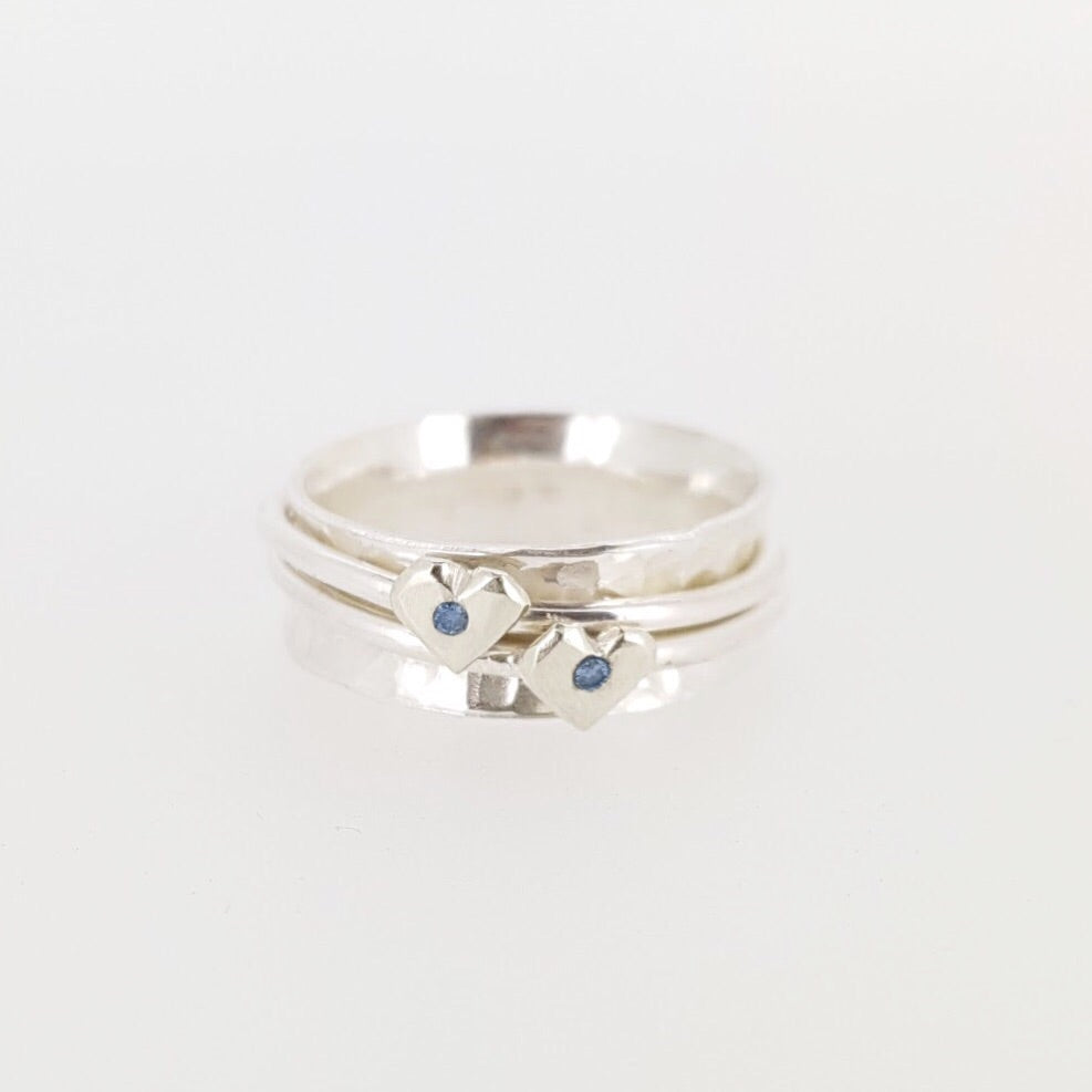 Silver spinning ring with silver hearts and sparkling sapphires