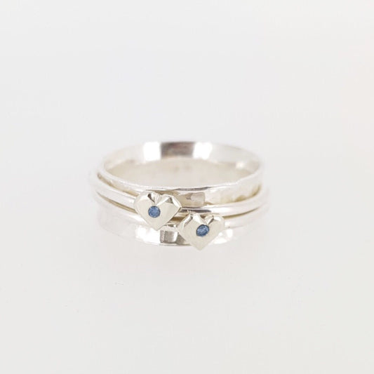 Silver spinning ring with silver hearts and sparkling sapphires