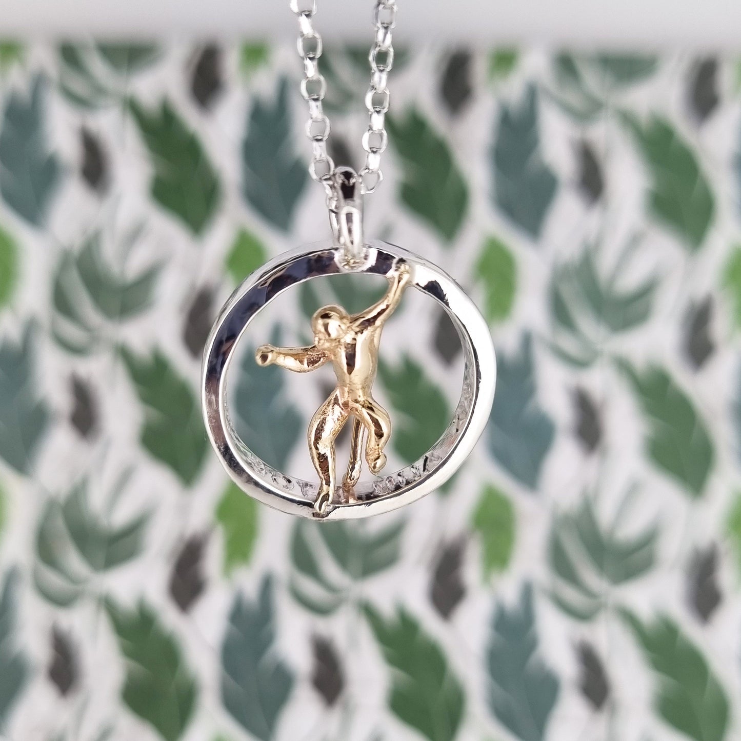 Teeny tiny gold monkey peeping out of silver halo