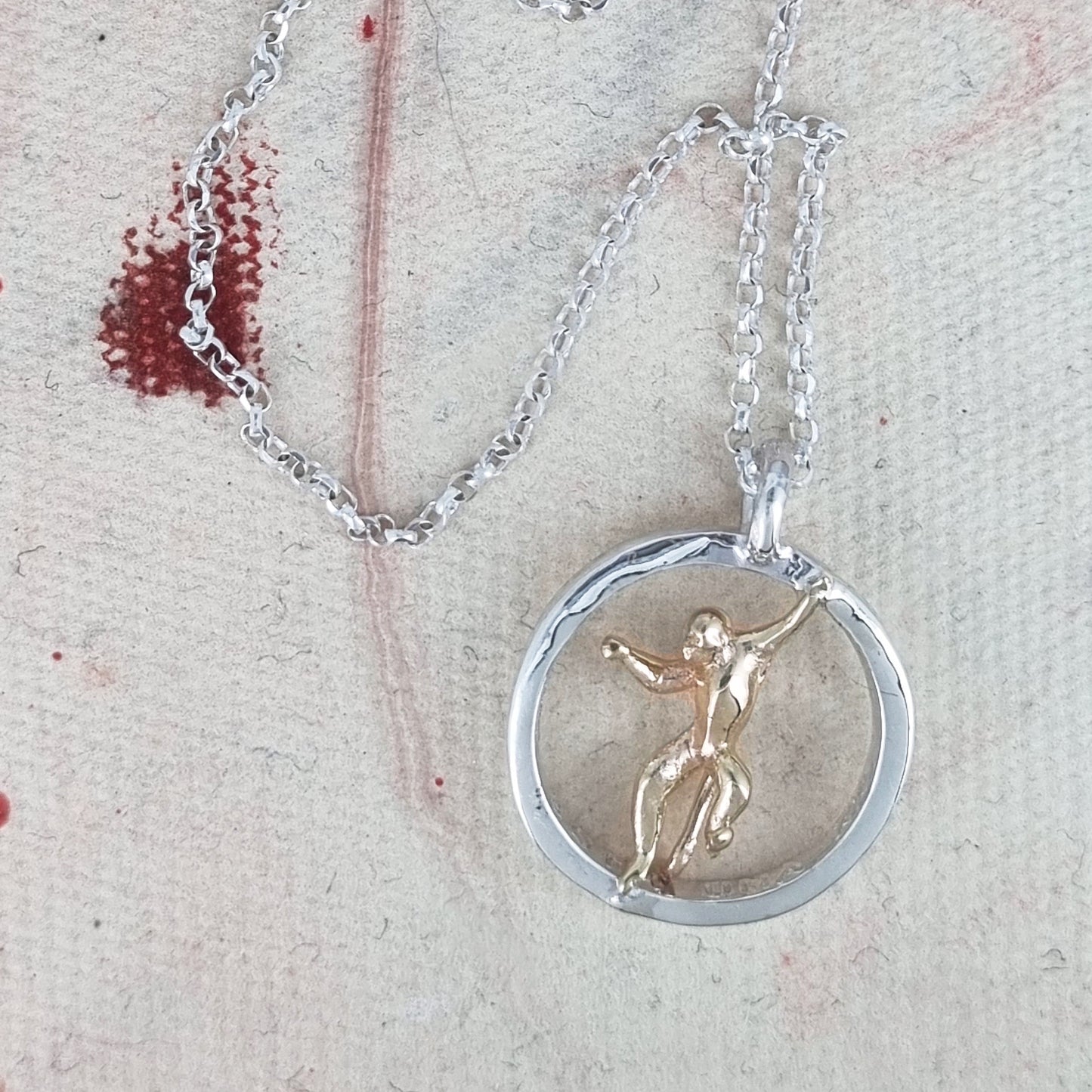 Teeny tiny gold monkey peeping out of silver halo