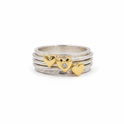 Spinning ring with diamonds set in three gold hearts