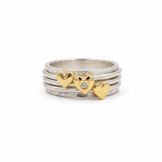 Spinning ring with diamonds set in three gold hearts