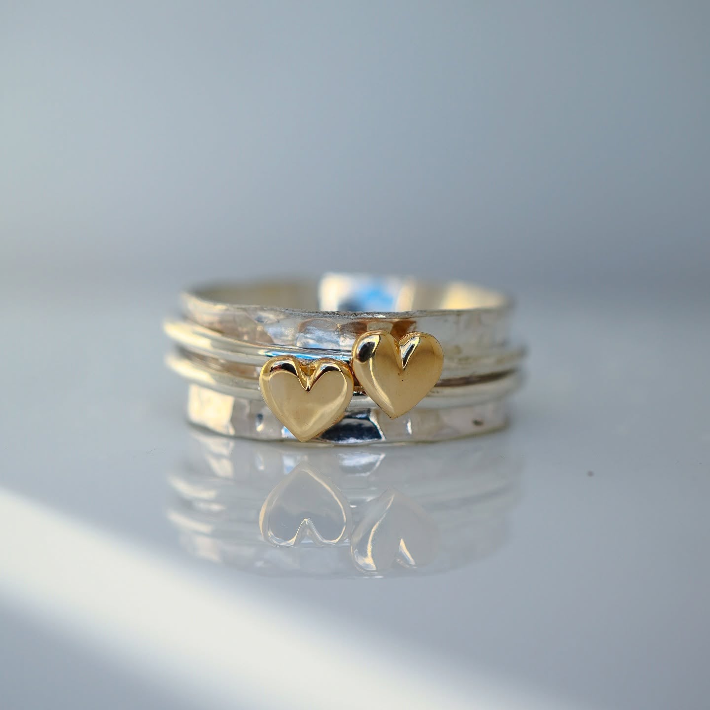 Two hearts beat as one. Gold or silver hearts.