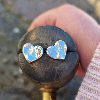 Silver hammered heart earrings.