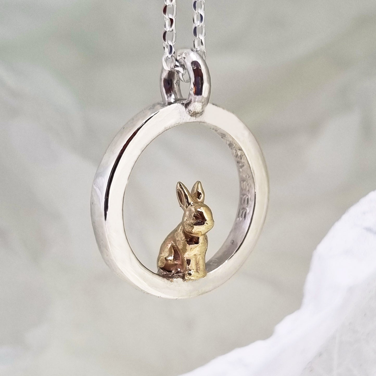 Teeny tiny gold bunny rabbit peeping out of silver halo