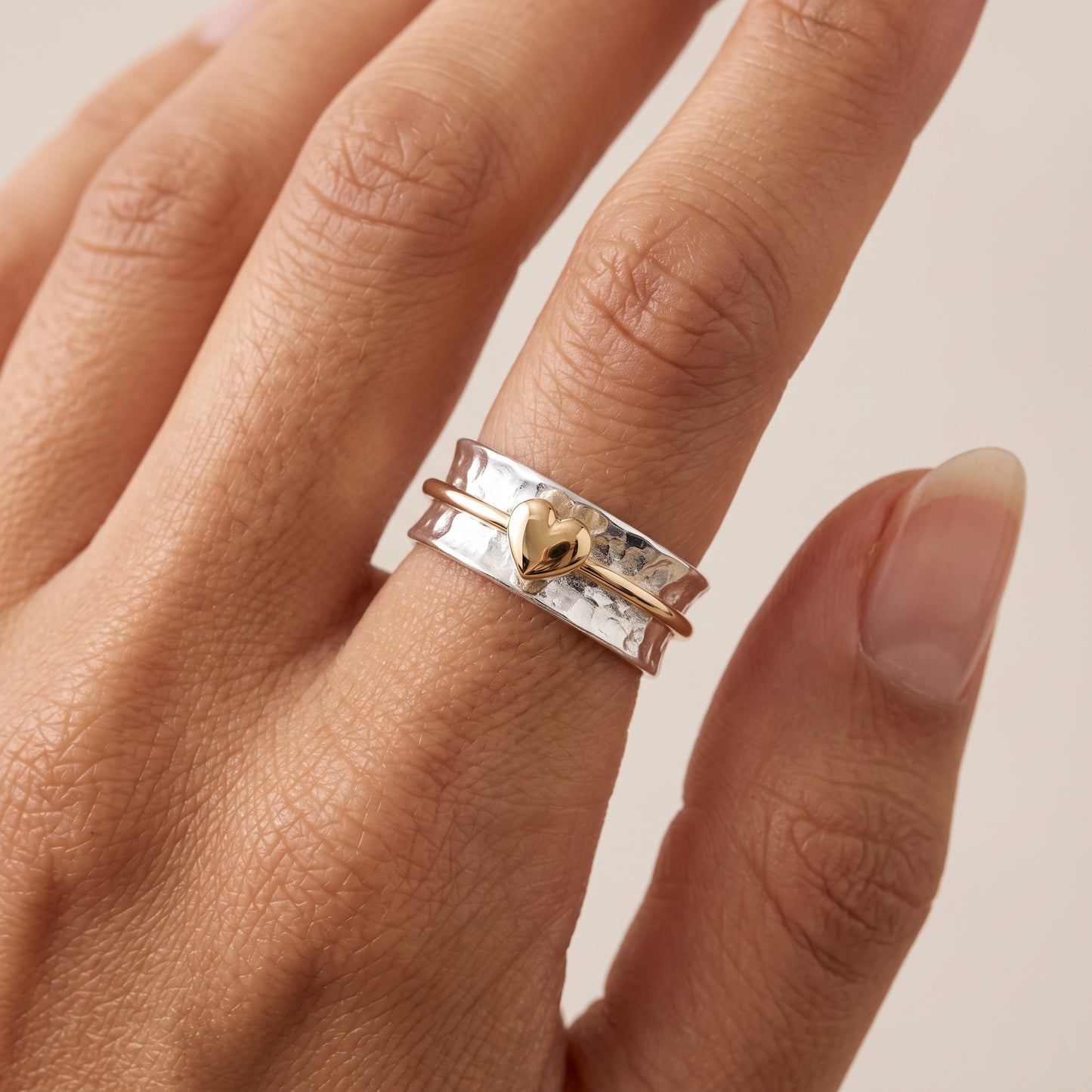'One Love'. Sterling silver ring with solid gold heart and spinning ring.