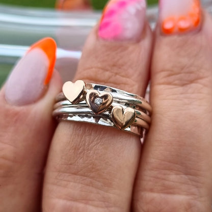 Spinning ring with diamonds set in three gold hearts