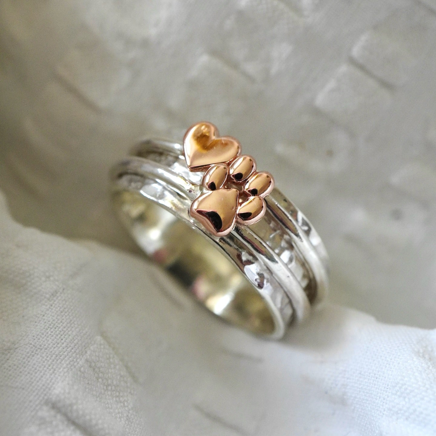 Paw spinning ring with solid gold or silver paw
