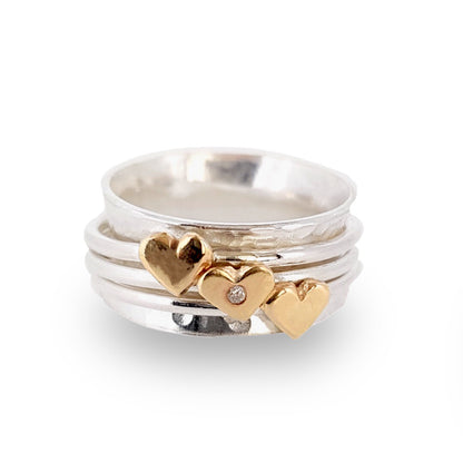 Spinning ring with diamonds set in three gold hearts
