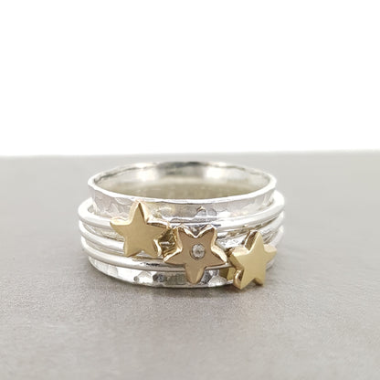 'It's in the stars' - spinning ring with diamonds set in three gold stars