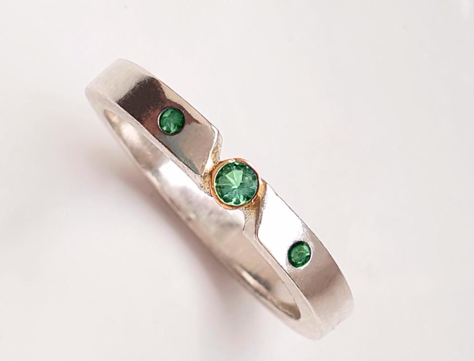Triple emerald ring with gold bezel setting