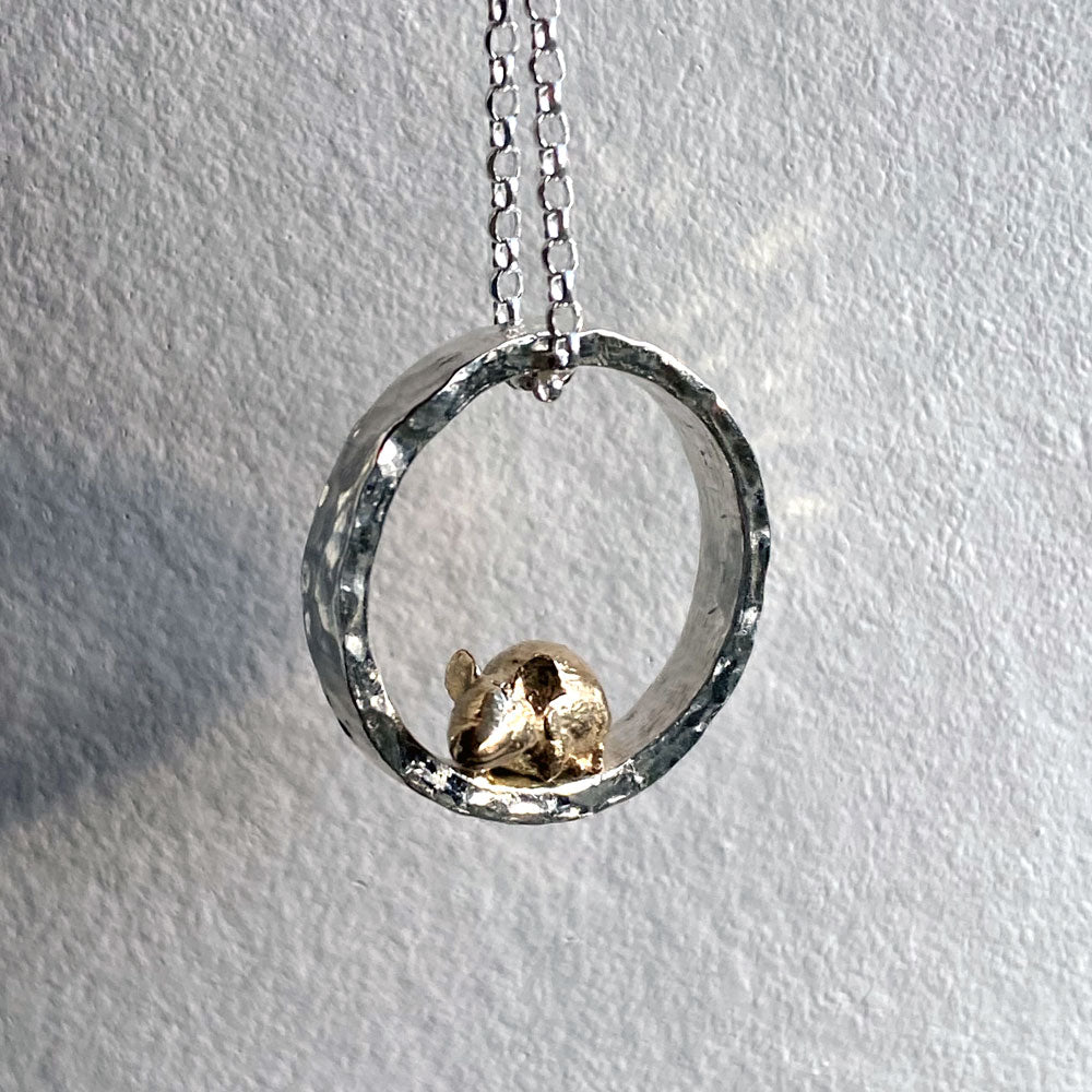 Teeny tiny gold mouse peeping out of silver halo